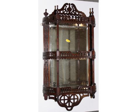 A mahogany three-tier wall shelf with fretwork galleries and mirror panels, 15" wide