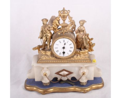 A late 19th Century gilt metal mounted mantel clock with attendant figures on marble base, 12" high, on gilt stand