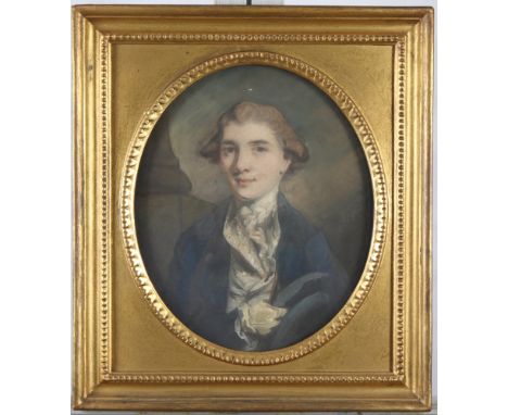 An 18th Century pastel and body colour portrait of a gentleman with kid gloves, 12" x 10", in oval mount and gilt frame