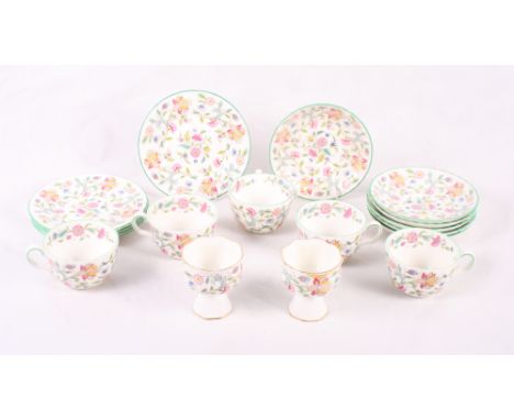 A Minton's "Haddon Hall" part tea service comprising five cups, five side plates, six saucers and two pedestal vases