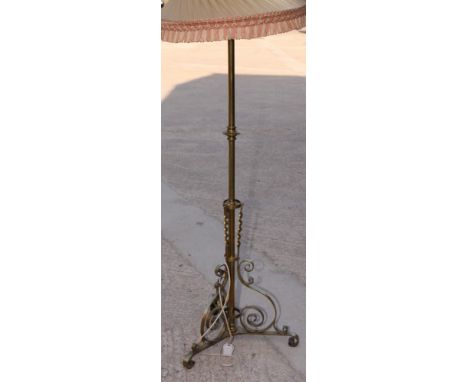 An early 20th Century brass standard lamp on tripod base