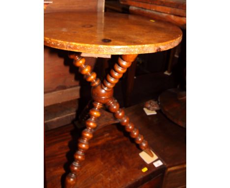A 19th Century circular gypsy table, on bobbin turned supports