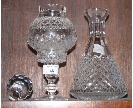 A hobnail cut decanter and stopper and a cut glass candlestick with globe shade