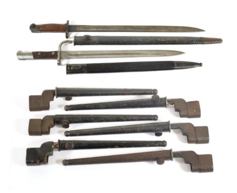 A British 1907 Bayonet, by Wilkinson, with steel mounted leather scabbard; six British No.4 Mk.II Spike Bayonets, with scabba