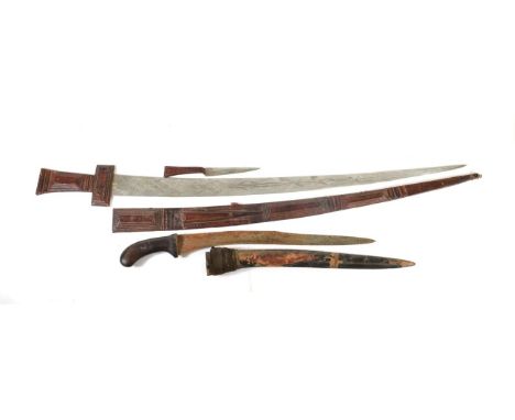 A Tuareg Takouba (Sword), North Africa, the 79cm double edge steel blade engraved with diapered panels, the cruciform hilt an