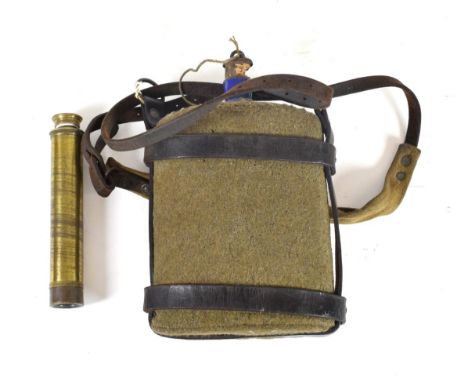 A First World War Water Canteen, the blue enamelled tin body covered in khaki wool, with leather and webbing harness and stra