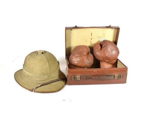 A Second World War RAF Issue Wolseley Helmet, with six panelled crown, three fold puggaree with RAF coloured flash, the brim 