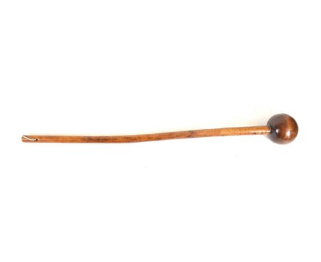 A Zulu Knobkerrie, of dense honey coloured wood, with globular head and tapering haft, 67cm.  Bruise and fine split to the he