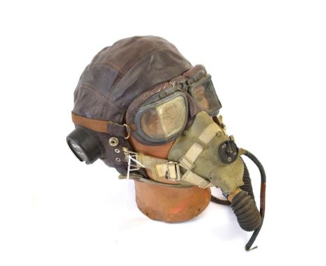 A Second World War Leather Flying Helmet, C type, the bakelite ear pieces with Air Ministry markings numbered 10 A/13466, wit