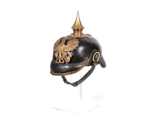 A Prussian Line Infantry E.M.'s Pickelhaube, with leather skull and peak, brass spike with five ventilation holes, brass spin