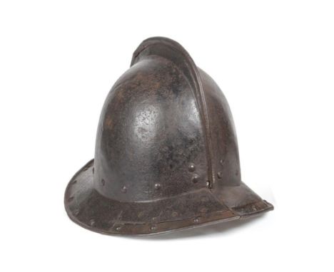 A 17th Century Pikeman's Pot Helmet, circa 1640, of two piece construction with folded seam to the shallow comb, the brim wit