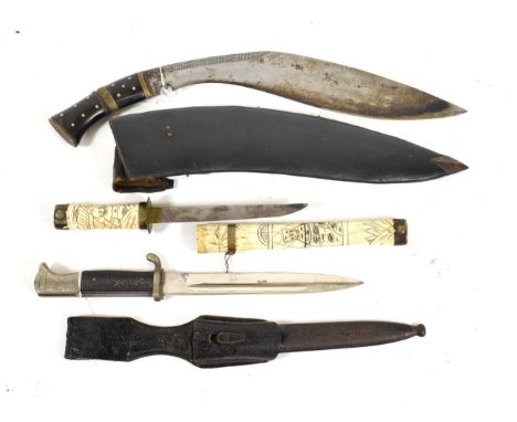 A German Third Reich Parade Bayonet, with unmarked steel blade, the plated white metal hilt with chequered black plastic grip