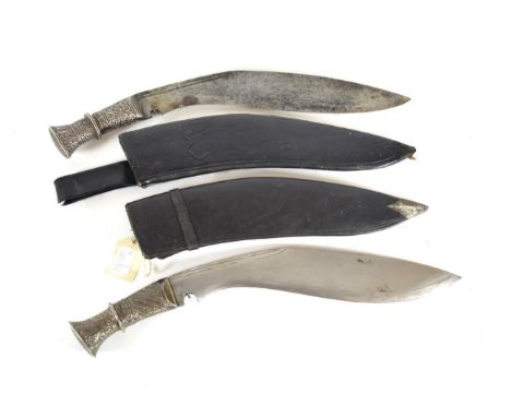 An Early 20th Century Nepalese Kukri, the 31cm broad curved steel blade with double fuller to the back edge, the silver cover