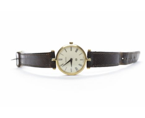 GUCCI WRIST WATCHthe round off white dial with Roman numerals in black, with Gucci crown, the 29mm case with red and green en