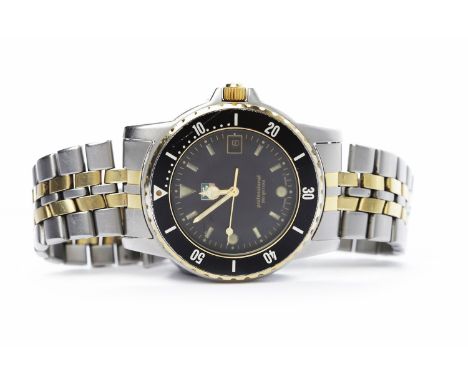 GENTLEMAN'S TAG HEUER STAINLESS STEEL PROFESSIONAL WRIST WATCHthe round black dial with applied shaped markers, with date ape
