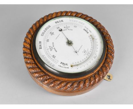 An Edwardian Circular Wall Hanging Aneroid Barometer with Carved Oak Rope Border, White Enamelled Dial Inscribed for Hopwood 