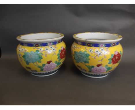 A pair of Chinese yellow ground pottery jardinières with enamel decoration of Asiatic pheasants, prunus blossom and lotus flo