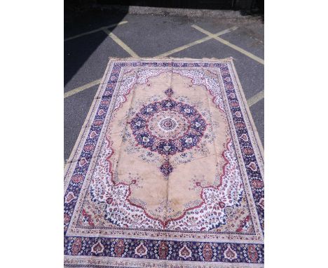 A Kashmiri carpet with blue borders and central medallion on a gold ground, 112'' x 80''