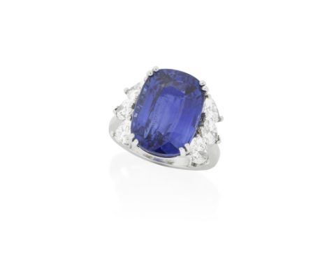 SAPPHIRE AND DIAMOND RINGThe cushion-shaped sapphire, weighing 16.38 carats, between pear-shaped and marquise-cut diamonds,  