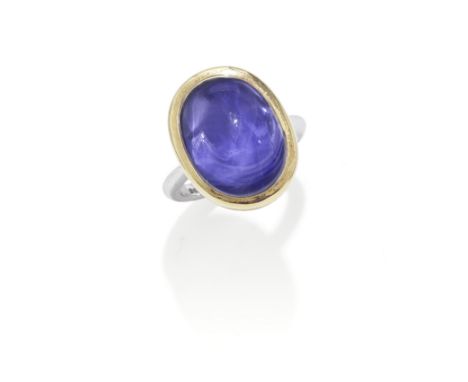 BOODLES: COLOUR-CHANGE SAPPHIRE RING, 1994The colour-change sugarloaf sapphire within a yellow gold collet, on a white gold b