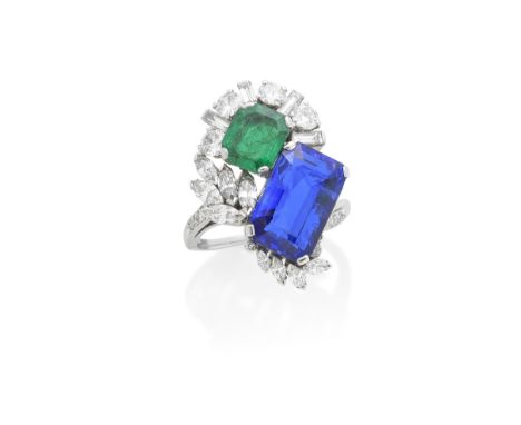 SAPPHIRE, EMERALD AND DIAMOND RINGThe step-cut sapphire, weighing 8.21 carats, obliquely-set with a step-cut emerald, weighin