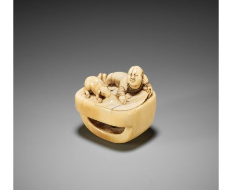 A CHARMING OLD IVORY NETSUKE WITH A BOY, SCROLL AND DOGJapan, 18th century, Edo period (1615-1868)The quite unusually-shaped 