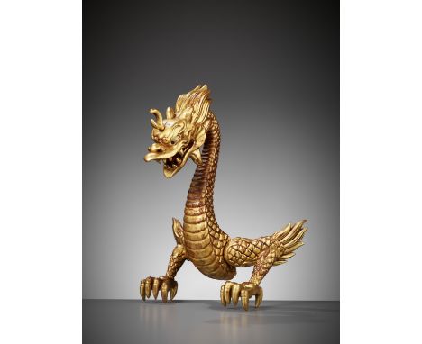 A RARE GOLD-LACQUERED WOOD MAEDATE IN THE FORM OF A DRAGONJapan, 19th century, Edo period (1615-1868)Boldly carved as a risin