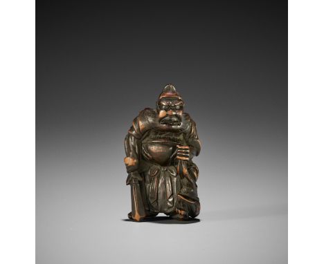 AN EDO SCHOOL WOOD NETSUKE OF SHOKI AND AN ONIJapan, Edo (Tokyo), 19th century, Edo period (1615-1868)The finely stained and 