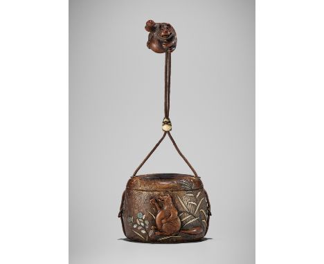 MINKO: A RARE TONKOTSU SET DEPICTING BELLY-DRUMMING TANUKIThe tonkotsu and netsuke signed Minko with kakihanJapan, Tsu, 19th 