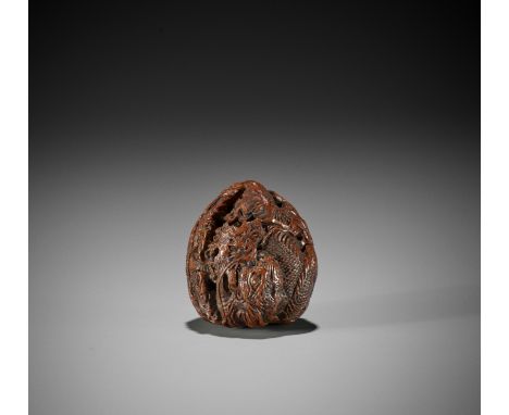A FINE WALNUT NETSUKE OF A DRAGONJapan, mid-19th century, Edo period (1615-1868)The kurumi netsuke very finely carved as a dr