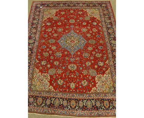 Persian Sarough red ground rug carpet, scrolling floral design, with blue medallion and border, 376cm x 275cm   Condition Rep