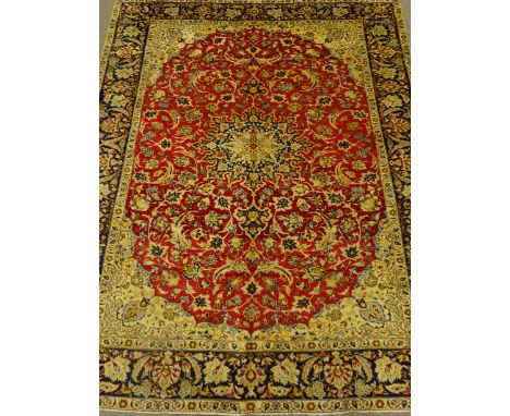 Iranian Najaf Abad rug carpet, cream ground with large red field, floral pattern with central medallion, blue border, 383cm x