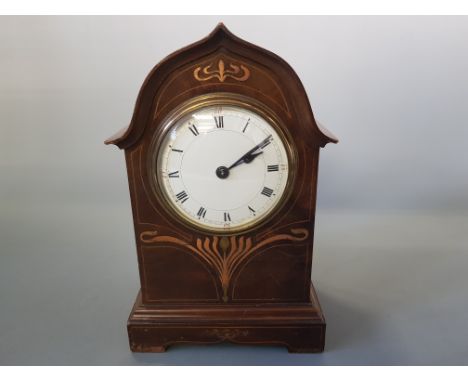 An Art Nouveau inlaid mahogany cased mantel clock with white enamel dial.