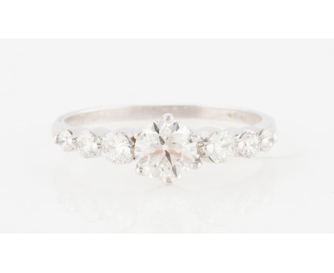 An 18ct white gold diamond ring, the principal round brilliant cut diamond measuring approx. 0.60ct, flanked to either side w