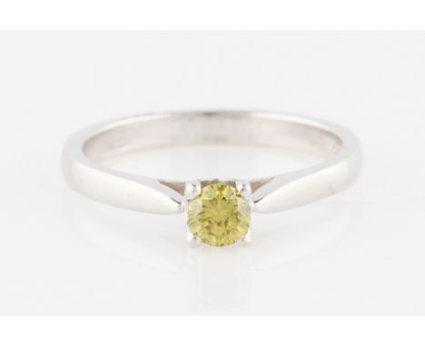 An 18ct white gold yellow diamond solitaire ring, set with a round brilliant cut yellow diamond, measuring approx. 0.35ct, ha