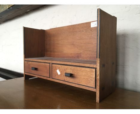 A small mahogany two drawer book shelf unit.