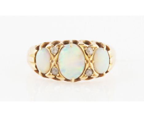 An opal and diamond ring, set with three graduated oval cut opal cabochons with rose cut diamond accents, markings rubbed, ri