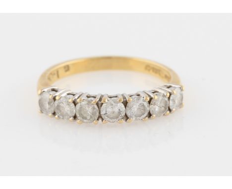 An 18ct yellow gold seven stone diamond half eternity ring, set with seven round brilliant cut diamonds, total diamond weight