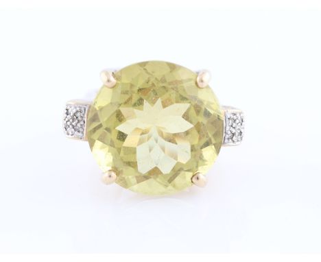 A 9ct yellow gold citrine and diamond dress ring, set with a round cut citrine, diameter approx. 20mm, flanked to either side