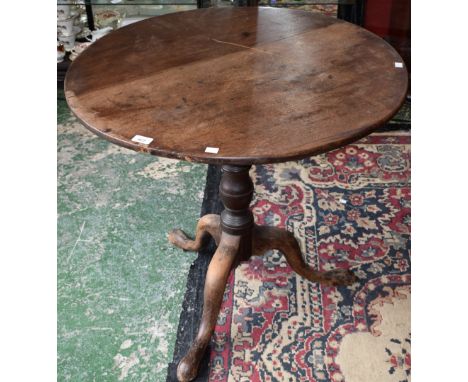 A George III mahogany tripod occasional table, near-circular tilting top, turned column, triform base, pad feet, 72cm high
