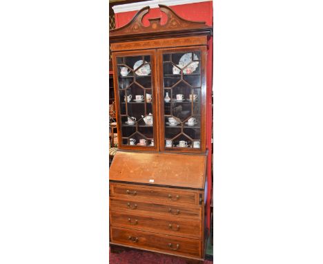 A Sheraton Revival mahogany and marquetry bureau bookcase, broken arch pediment above a frieze inlaid with ribbon-tied traili