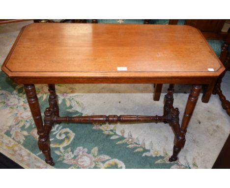 An Edwardian mahogany centre table, chamfered rectangular top, ring turned supports and stretcher, casters, 91cm wide