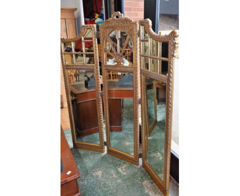 A French design 'giltwood' three fold screen, each panel mirrored with foliate gadrooned borders, 178.5cm high