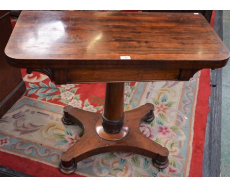 A William IV rosewood card table, hinged rectangular top enclosing a baize lined playing surface, spreading cylindrical colum