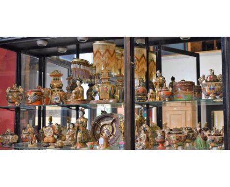 A Satsuma table lamp, as a seated woman with lap dog; another, as an elephant, glass bead shade; a Satsuma lidded jar; a figu