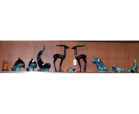A Poole Pottery model, of a leaping dolphin; another, similar; a Poole Pottery whale; others, crocodile, leaping trout, frog,