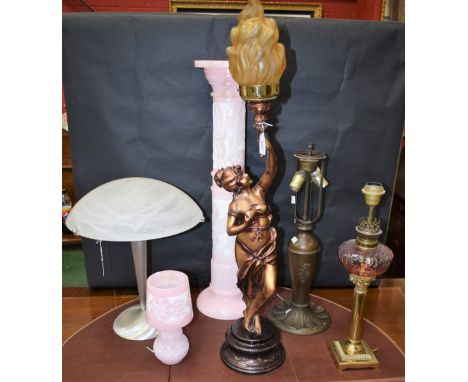 A reconstituted pink stone lamp stand and lamp; a figural lamp holding flaming torch; a Leviton lamp base; converted Corinthi