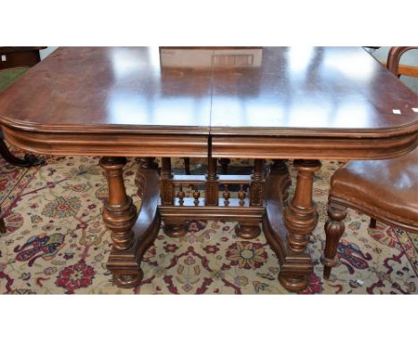 A 19th century mahogany dining table, rounded near-square top, ring turned baluster corner supports centred by three further 