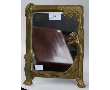 An Art Nouveau design brass rounded rectangular easel photograph frame, cast with a languid beauty and flowers to angles, sha