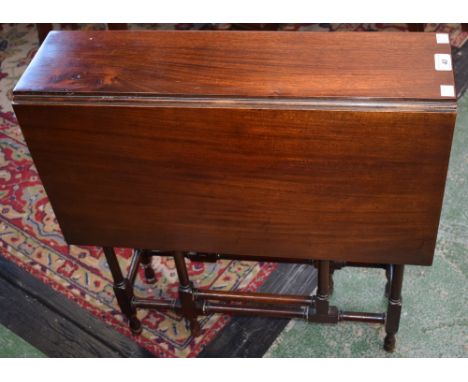 An early 20th century mahogany Sutherland table, rectangular top with fall leaves, ring turned supports and stretchers, 62.5c